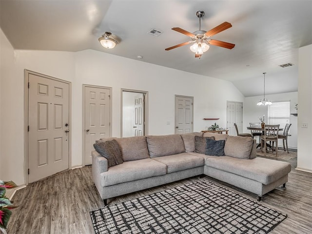 623 SW 37th St, Moore, OK 73160 - living room featuring lofted ceiling, wood finished floors, a ceiling fan, and a chandelier