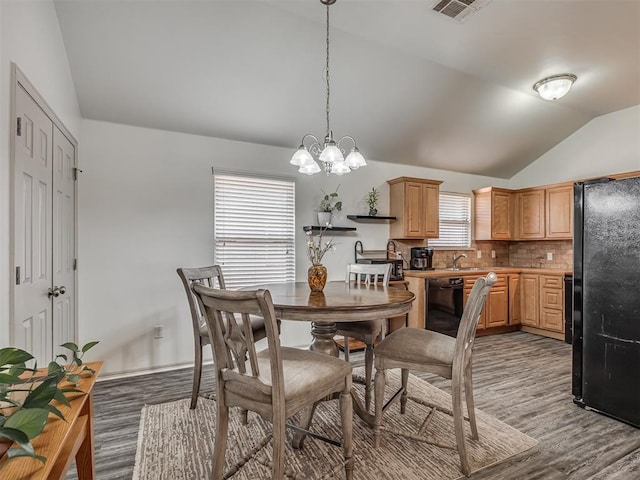 623 SW 37th St, Moore, OK 73160 - dining area with lofted ceiling, a chandelier, and light wood finished floors