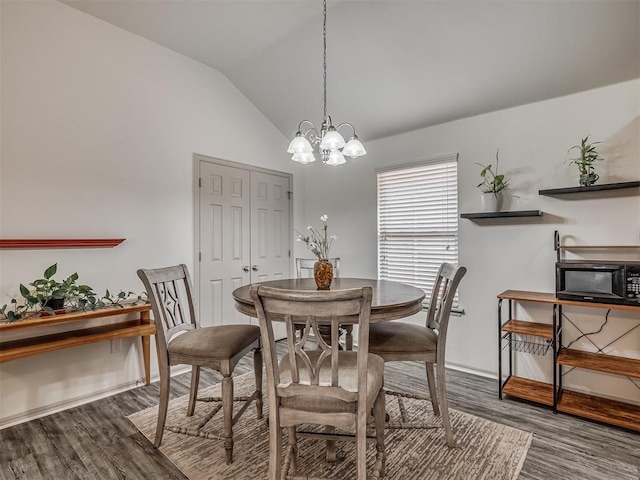 623 SW 37th St, Moore, OK 73160 - dining space with wood finished floors, vaulted ceiling, and a chandelier