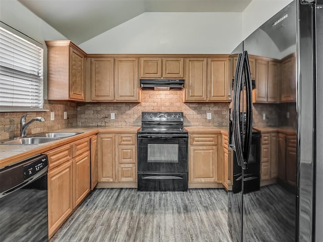 623 SW 37th St, Moore, OK 73160 - kitchen with black appliances, vaulted ceiling, light wood finished floors, decorative backsplash, and under cabinet range hood
