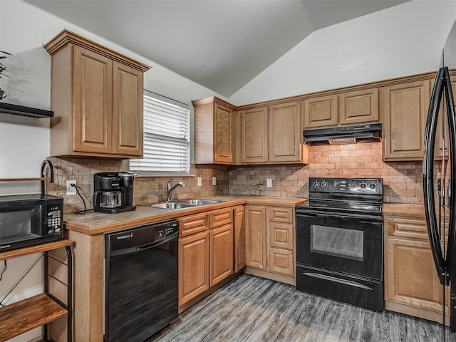 623 SW 37th St, Moore, OK 73160 - kitchen with black appliances, lofted ceiling, light wood-style floors, tile counters, and under cabinet range hood
