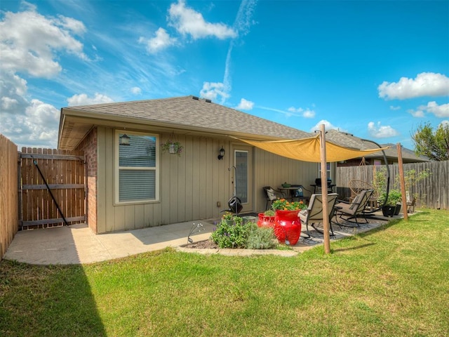 623 SW 37th St, Moore, OK 73160 - back of property with a shingled roof, a patio area, a fenced backyard, and a gate