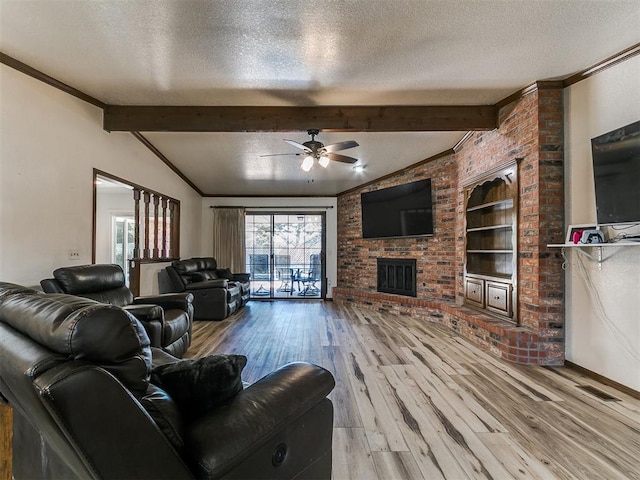 6105 W Gun Hill Way, Warr Acres, OK 73132 - living room featuring a textured ceiling, a ceiling fan, wood finished floors, a fireplace, and crown molding
