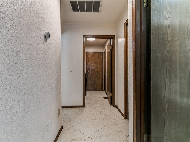 6105 W Gun Hill Way, Warr Acres, OK 73132 - hall with a textured wall and light tile patterned flooring