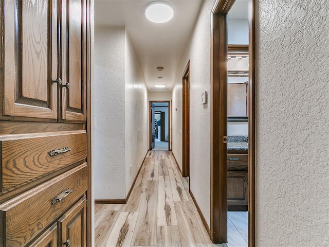 6105 W Gun Hill Way, Warr Acres, OK 73132 - corridor with a textured wall and light wood-style floors