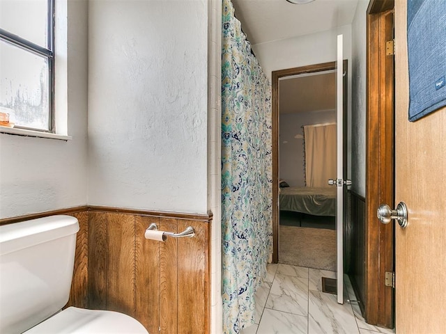 6105 W Gun Hill Way, Warr Acres, OK 73132 - ensuite bathroom featuring marble look tile flooring and curtained shower
