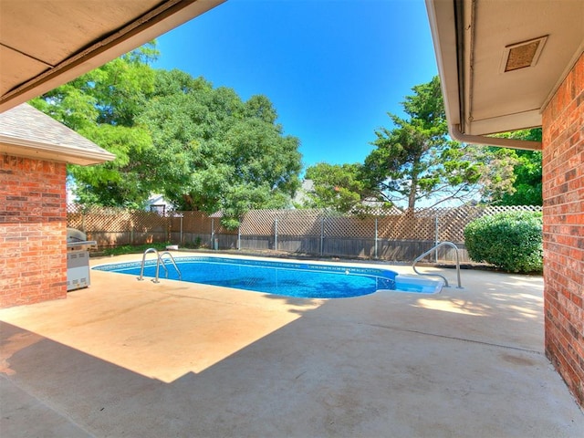 6105 W Gun Hill Way, Warr Acres, OK 73132 - view of pool with a fenced backyard, a patio area, and a grill