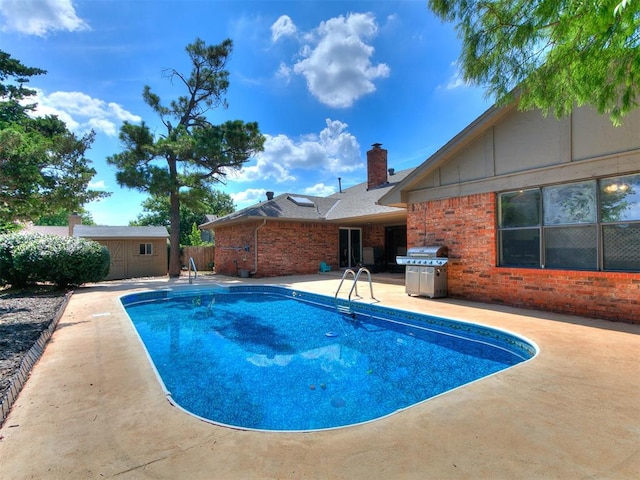 6105 W Gun Hill Way, Warr Acres, OK 73132 - swimming pool featuring grilling area, a patio, and a storage unit