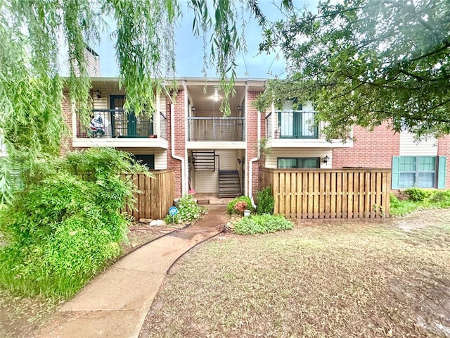 4400 Hemingway Dr Unit 202, Oklahoma City, OK 73118 - back of property featuring a balcony, brick siding, and a chimney