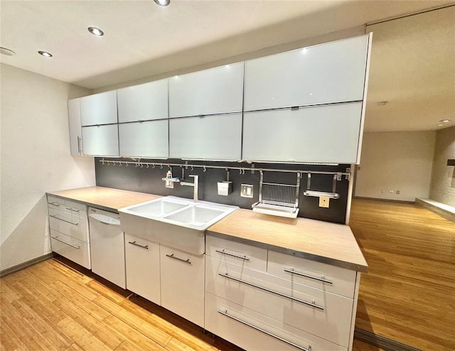 4400 Hemingway Dr Unit 202, Oklahoma City, OK 73118 - kitchen with light wood-type flooring, white dishwasher, backsplash, recessed lighting, and light countertops