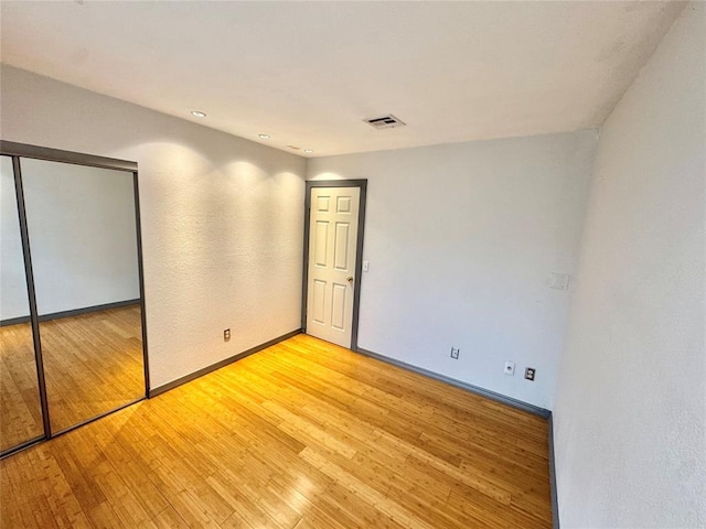 4400 Hemingway Dr Unit 202, Oklahoma City, OK 73118 - unfurnished bedroom featuring light wood-style flooring and a closet
