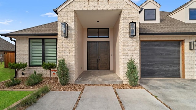10105 SW 25th Ct, Yukon, OK 73099 - property entrance with a shingled roof, driveway, an attached garage, and brick siding