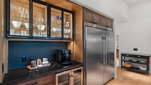 10105 SW 25th Ct, Yukon, OK 73099 - indoor dry bar featuring stainless steel built in refrigerator, beverage cooler, and light wood-style flooring