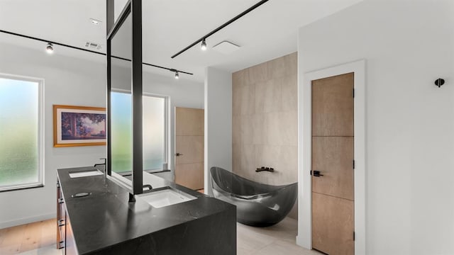 10105 SW 25th Ct, Yukon, OK 73099 - bathroom featuring vanity, a freestanding bath, and track lighting