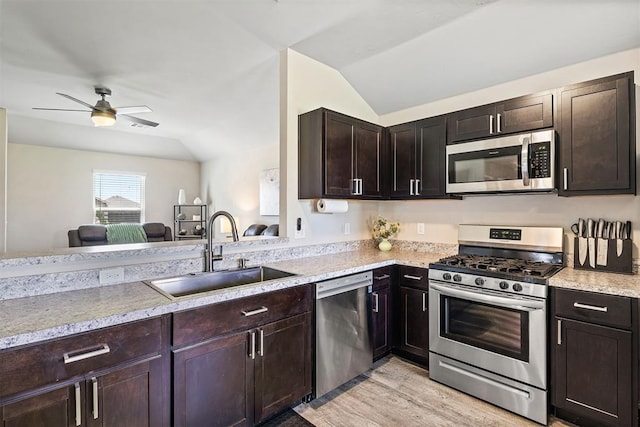 521 Audrey Dr, Tuttle, OK 73089 - kitchen with stainless steel appliances, lofted ceiling, a ceiling fan, light wood-type flooring, and dark brown cabinetry