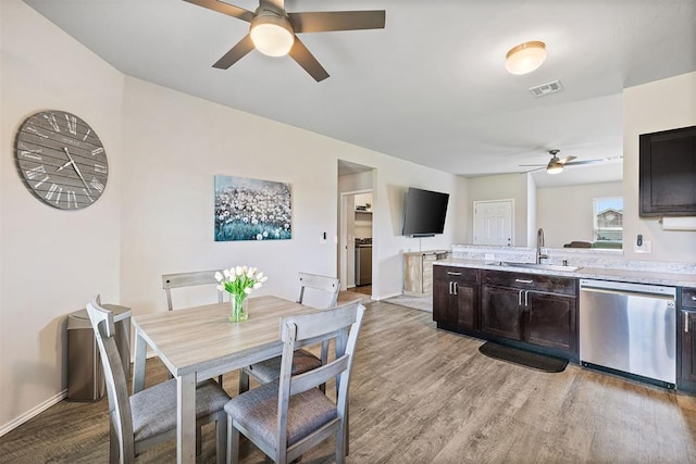 521 Audrey Dr, Tuttle, OK 73089 - kitchen with ceiling fan, light countertops, dishwasher, and light wood-style floors