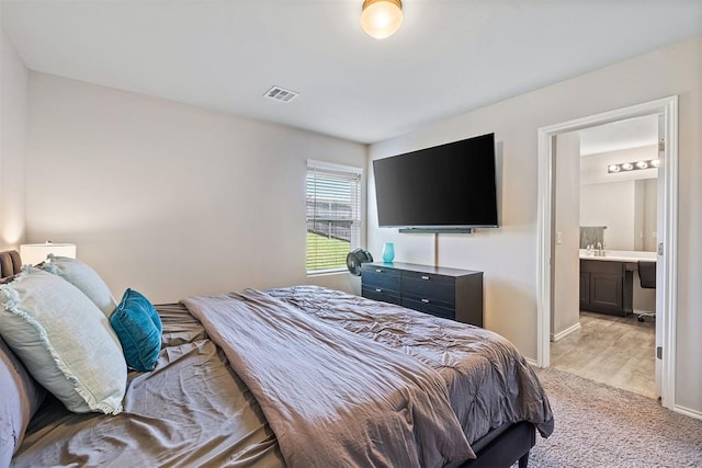 521 Audrey Dr, Tuttle, OK 73089 - bedroom featuring light carpet and ensuite bath