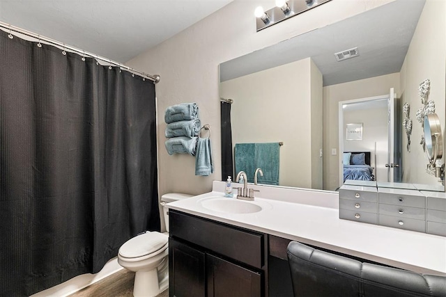 521 Audrey Dr, Tuttle, OK 73089 - full bathroom with ensuite bathroom, vanity, a shower with shower curtain, and wood finished floors