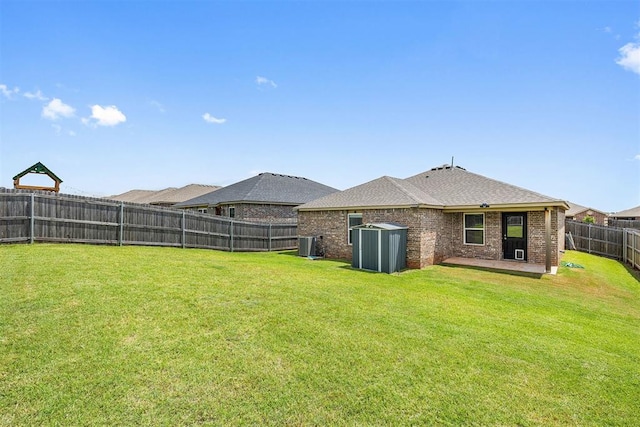 521 Audrey Dr, Tuttle, OK 73089 - fenced backyard featuring a patio and a storage shed