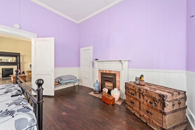 508 Newton Ave, Ozark, AL 36360 - bedroom with a brick fireplace, ornamental molding, hardwood / wood-style flooring, and a wainscoted wall
