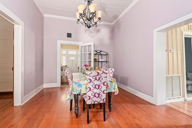 508 Newton Ave, Ozark, AL 36360 - dining area featuring a chandelier, baseboards, wood finished floors, and ornamental molding