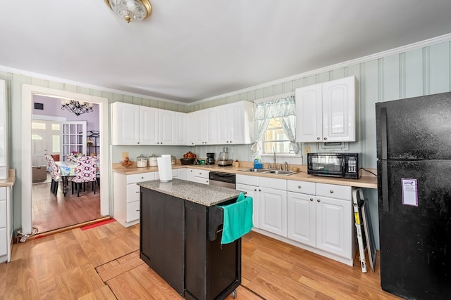 508 Newton Ave, Ozark, AL 36360 - kitchen featuring black appliances, a sink, crown molding, white cabinets, and light wood finished floors