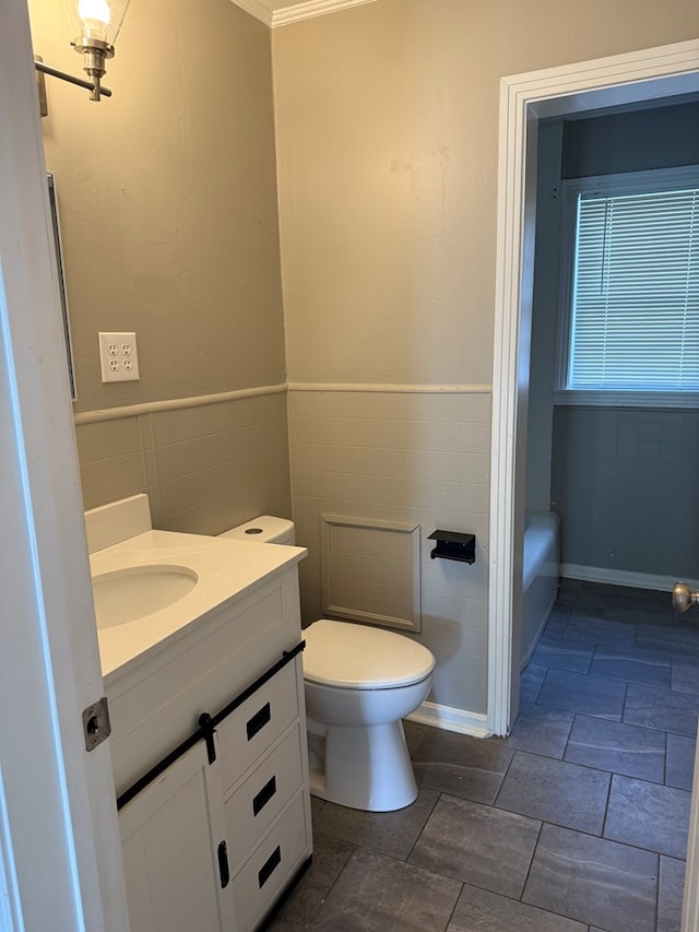 123 Hedstrom Dr, Dothan, AL 36301 - full bath featuring vanity, tile walls, a tub, and a wainscoted wall