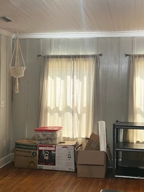 sitting room with wooden ceiling, visible vents, crown molding, and wood finished floors