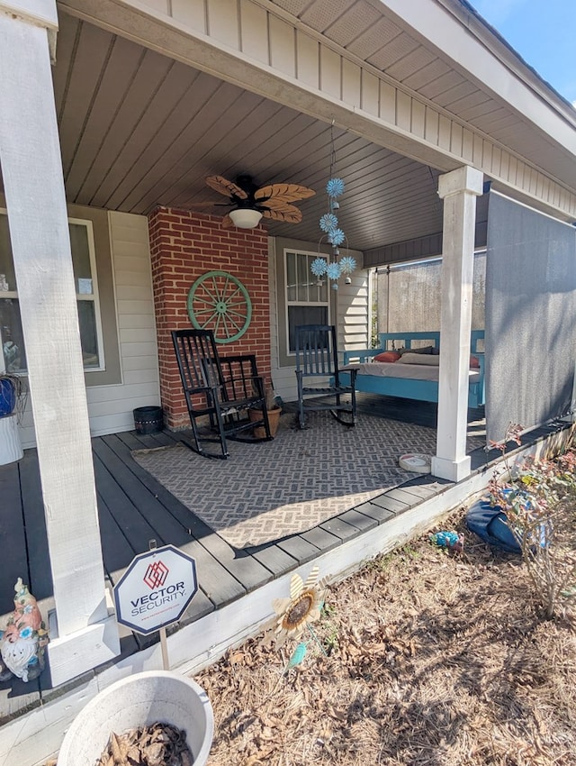 deck featuring covered porch and ceiling fan