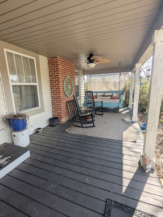 wooden terrace featuring a ceiling fan and covered porch