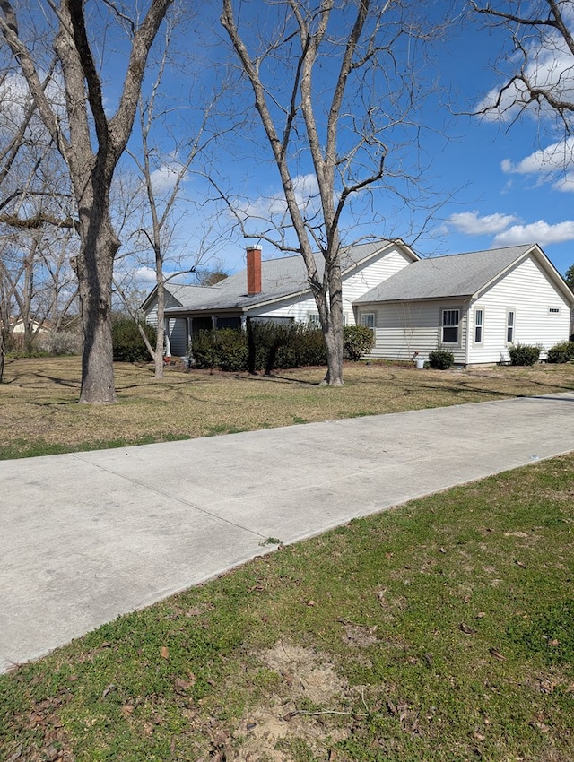 view of yard with concrete driveway