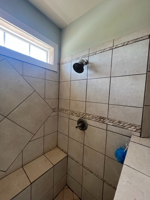 full bathroom with tiled shower