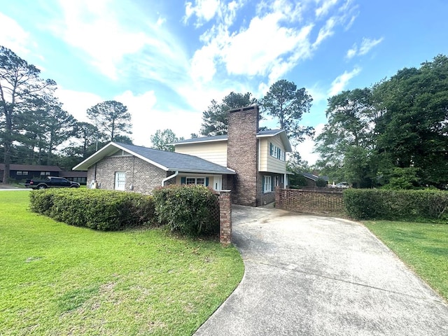 2403 Stonebridge Rd, Dothan, AL 36301 - view of front of property with driveway, a chimney, a front yard, and brick siding