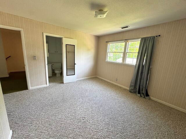 2403 Stonebridge Rd, Dothan, AL 36301 - unfurnished room featuring wallpapered walls, a textured ceiling, carpet, and baseboards
