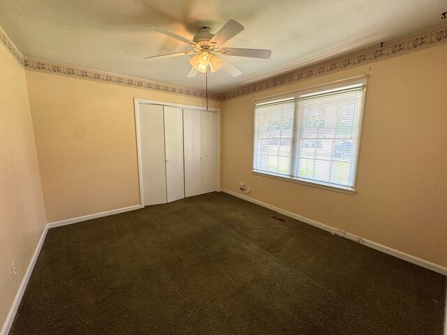 2403 Stonebridge Rd, Dothan, AL 36301 - unfurnished bedroom with a closet, dark colored carpet, baseboards, and a ceiling fan