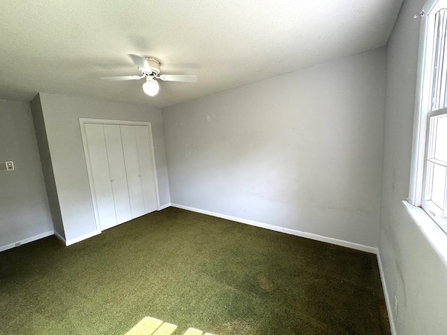 2403 Stonebridge Rd, Dothan, AL 36301 - unfurnished bedroom featuring dark carpet, a closet, baseboards, ceiling fan, and a textured ceiling