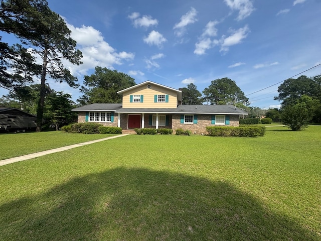 2403 Stonebridge Rd, Dothan, AL 36301 - traditional-style house with brick siding, a front yard, and a porch