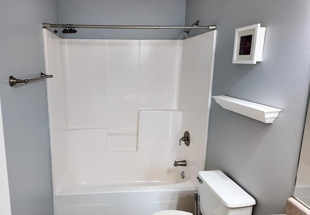 bathroom with toilet and tub / shower combination
