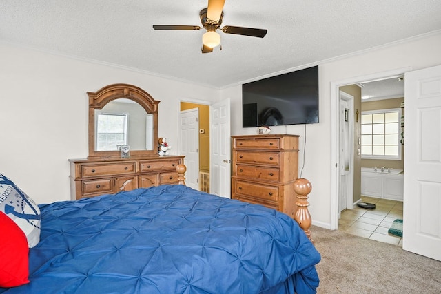 bedroom featuring ornamental molding, a ceiling fan, light carpet, connected bathroom, and a textured ceiling