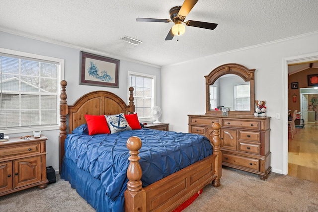 bedroom featuring ceiling fan, a textured ceiling, light carpet, visible vents, and ornamental molding