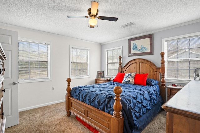 bedroom featuring light carpet, baseboards, visible vents, and a textured ceiling