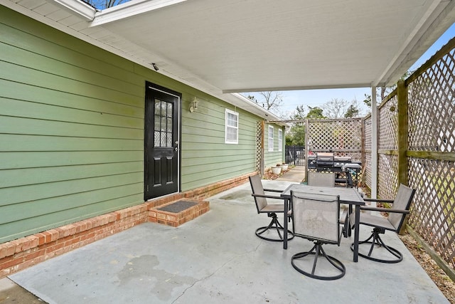 view of patio featuring fence and outdoor dining area