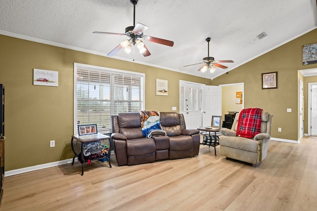 living room featuring lofted ceiling, visible vents, and crown molding