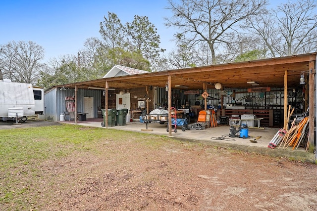 back of house featuring an outbuilding, a yard, and an outdoor structure