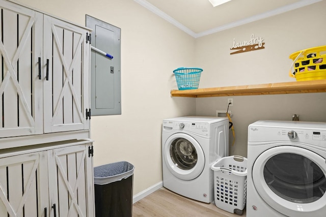 laundry room featuring cabinet space, washing machine and dryer, electric panel, and ornamental molding