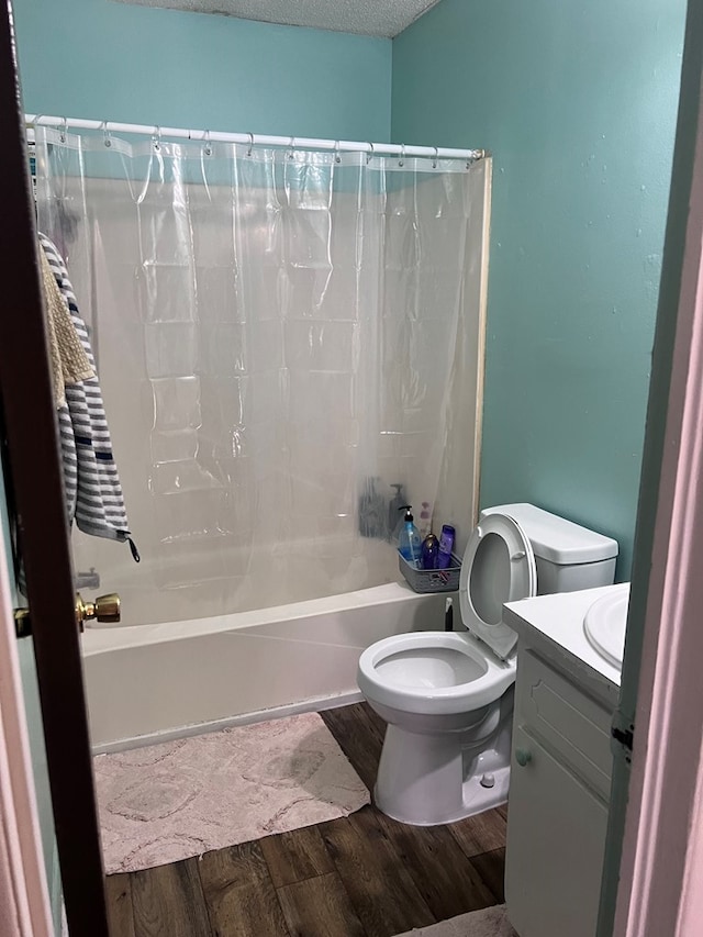 full bathroom featuring a textured ceiling, toilet, vanity, shower / tub combo, and hardwood / wood-style flooring