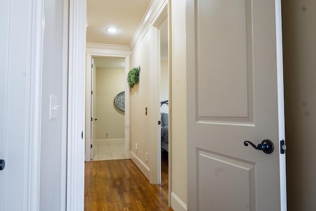 hall featuring crown molding and dark hardwood / wood-style flooring