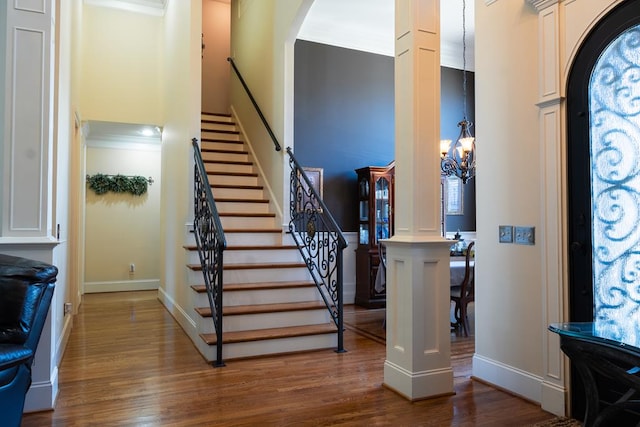 foyer entrance featuring wood-type flooring and a notable chandelier