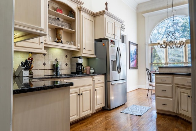 kitchen with stainless steel fridge, crown molding, hardwood / wood-style flooring, decorative light fixtures, and a chandelier