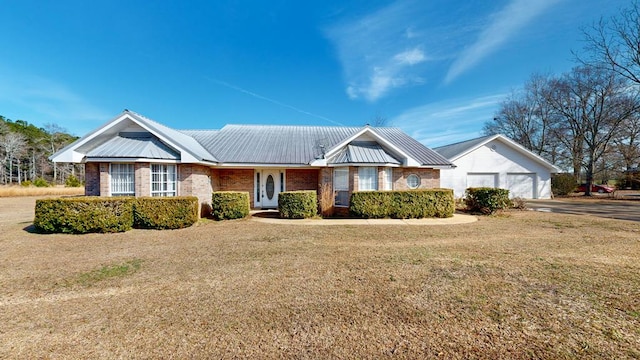 ranch-style home with a garage and a front yard